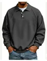Detail view of charcoal gray polo sweatshirt with ribbed shoulder panels and white buttons - Black