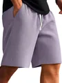Detailed close-up of lavender waffle knit men's casual summer shorts with white drawstring - Purple