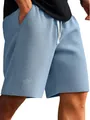 Close-up of blue waffle knit shorts showing detailed fabric texture and white drawstring. - Light Blue