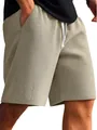Close-up of men's beige waffle knit shorts with adjustable white drawstring - Khaki