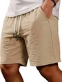 Close-up of khaki textured casual shorts featuring drawstring waist and side pocket - Khaki