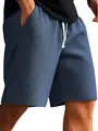 Close-up of men's blue waffle knit casual shorts with drawstring waist and textured detail - Navy Blue