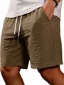 Close-up of men's textured brown summer casual shorts with adjustable drawstring. - S / Bottoms / Brown