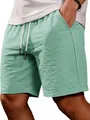 Detailed close-up view of light green textured casual shorts for men with drawstring - Light Green
