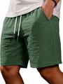 Detailed view of men's casual green shorts with textured fabric and white drawstring - Army Green