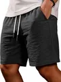 Close-up of men's dark grey casual shorts with textured fabric and drawstring. - Black