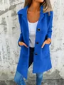 Detailed view of women's vibrant blue mid-length faux fur coat with lapels and buttons - S / Tops / Blue