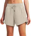 Detailed view of beige 5-inch quick-dry running shorts with zip pockets and drawstring waist - Khaki