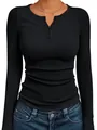 Macro view of a black ribbed slim fit long sleeve knit top with buttoned Henley neckline - S / Tops / Black