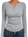 Close-up of women's gray ribbed knit long-sleeved Henley top with button details - Light Gray