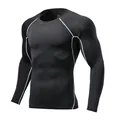Detail of black long sleeve compression shirt with white contrast stitching - Size 22 / Tops / Black/Grey