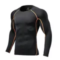 Detailed view of black long-sleeve compression shirt with orange contrast stitching - Size 22 / Tops / Black/Orange
