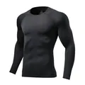 Close-up detail of black quick-dry long sleeve compression shirt with a comfortable round neck. - Size 22 / Tops / Black/Black