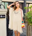Full body view of a model in a beige crochet beach cover-up with fringe details - One Size / Tops / Apricot