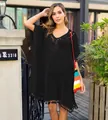 Detail view of black crochet tassel beach cover-up shown on a fashion model outdoors - One Size / Tops / Black