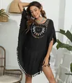 Detail view of black crochet beach cover-up featuring intricate hollow-out chest design - One Size / Tops / Black