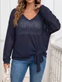Detailed shot of a navy blue V-neck crochet sweater with a knot hem detail. - One Size / Tops / Navy Blue