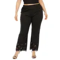 Detailed view of women's black pants featuring elegant laser-cut floral hem detail. - 1XL / Bottoms / Black