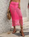 Detail view of a pink crochet beach skirt with long tassel fringe and drawstring waist. - S / Bottoms / Rose Red