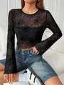 Detail view of sheer black mesh top featuring spider web pattern and ruffled edges - S / Tops / Black