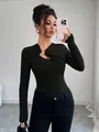 Stylish black long-sleeve slim fit top featuring an asymmetric cutout with metal ring detail - S / Black