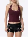 Close-up of maroon halter neck crop top featuring silver eyelet details on U-neckline. - S / Tops / Burgundy
