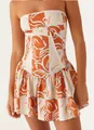 Close-up detail view of a strapless summer mini dress with orange and white floral pattern - Multicolor Pattern