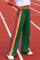 Detail view of women's green wide-leg lounge pants with colorful rainbow side stripes - S / Bottoms / Green