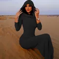 Close-up view of the slim fit hooded black maxi dress against a desert backdrop. - S / Long Sleeve (Bottom) / Black