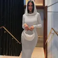 Model wearing a white long sleeve hooded bodycon maxi dress in a modern indoor setting - S / Top And Bottom / Gray