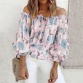 Close-up of elegant off-shoulder pink chiffon blouse with vibrant blue floral print - S / Tops / Pink