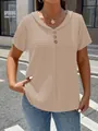 Detail view of beige V-neck short sleeve top with textured fabric and button accents. - Apricot