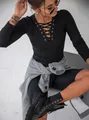 Detail shot of the crisscross lace-up V-neckline on a black ribbed knit long sleeve top - S / Tops / Black