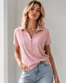 Detailed close-up of a pink ribbed polo shirt featuring a stylish ring zipper pull and casual fit - S / Tops / Pink