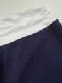 Close-up macro detail of the white elastic waistband on navy blue yoga pants fabric - S / Bottoms / Navy Blue