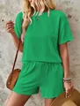 Detailed view of women's ribbed green two-piece set featuring a short-sleeve top and shorts. - Green