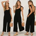 Detail view of a black summer jumpsuit with bow straps showing front and back angles. - S / Top And Bottom / Black