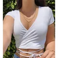Gros plan d'un crop top blanc à col en V avec des lanières de taille ajustables - S / Hauts / Blanc