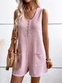 Close-up of pink waffle-knit button-front romper with pockets and elegant sleeveless design. - S / Pink
