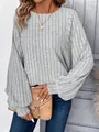 Close-up of a women's grey ribbed knit sweater featuring elegant lantern sleeves and a crew neck. - Gray