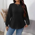 Detailed view of women's plus size black quilted sweatshirt with textured grid pattern. - XL / Tops / Black