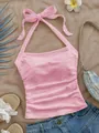Vista detallada del top rosa texturizado con cuello halter y lazo muy elegante - S / Tops / Rosa