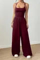Detail of a burgundy sleeveless jumpsuit with ruched waist and wide leg design. - S / Top And Bottom / Burgundy