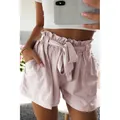 Detail view showing high-waisted paper-bag shorts in mauve with bow belt and pockets - S / Bottoms / Apricot