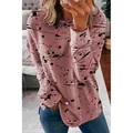 Detailed view of women's pink long-sleeved sweatshirt with stylish black ink splatter pattern - 3XL / Tops / Graffiti Pink