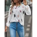 Detail of white V-neck long sleeve blouse featuring vibrant feather print and elastic cuffs - S / Tops / White