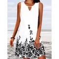 Detailed view of white sleeveless dress featuring black floral print and neck cutout. - S / Top And Bottom / White