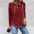 Detailed view of wine red long sleeve T-shirt featuring buttoned irregular hem detail. - Burgundy