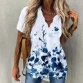 Close-up of white short sleeve blouse featuring a wavy V-neck and blue ink floral patterns - S / Tops / Blue Floral