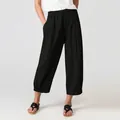 Detail view of women's black loose casual trousers with elastic waist and cuffed hem. - S / Bottoms / Black